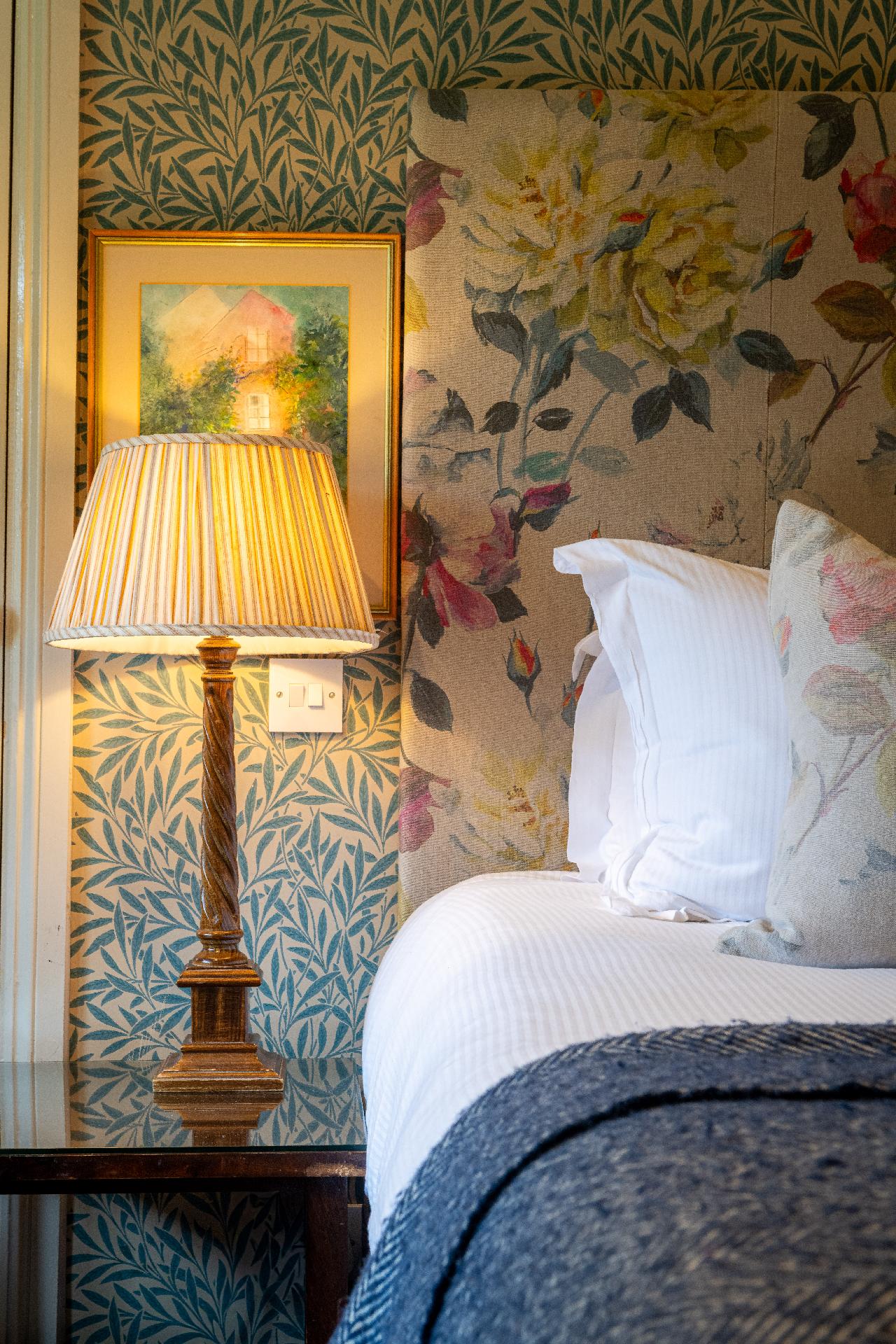 Bed with bedside table and reading lamp